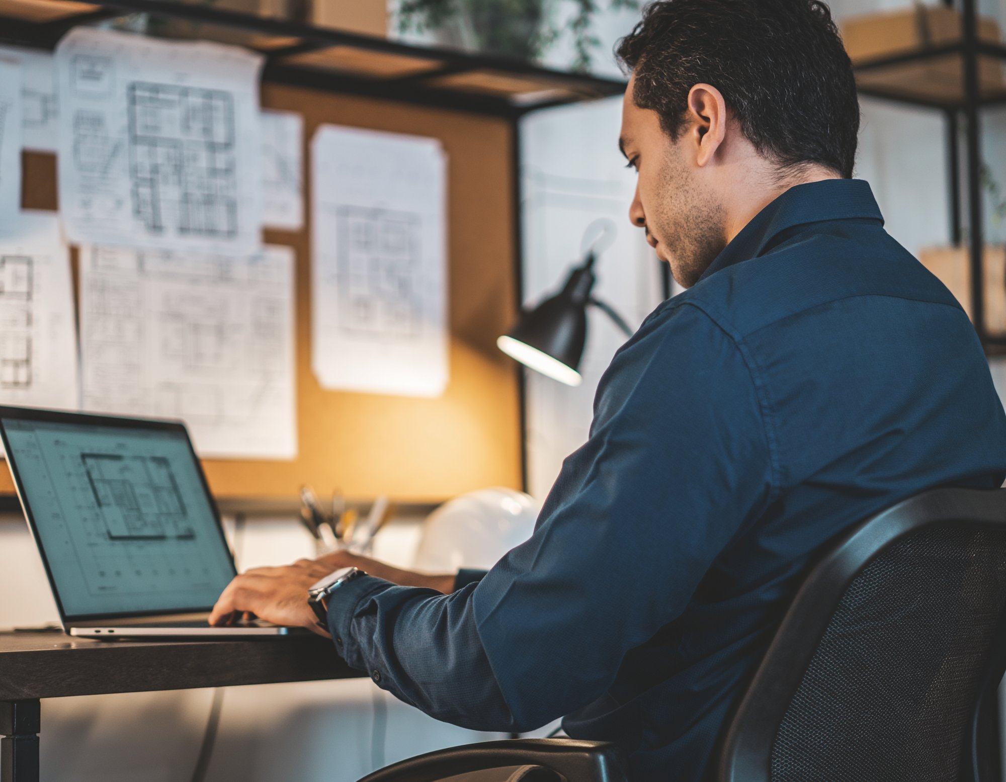 Firefly_a wide shot from behind of A male architect on the computer enrolling in a program 347768