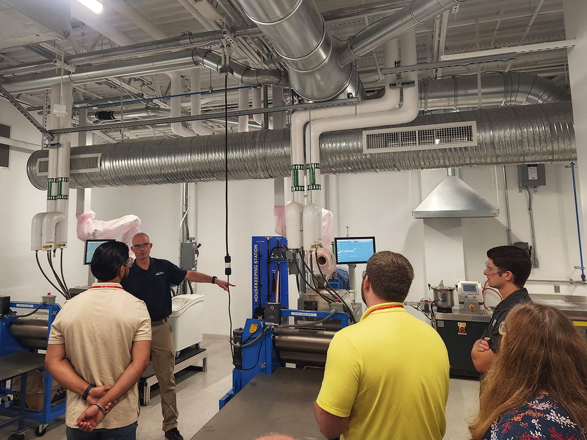 TCI chemist leading attendees through tour